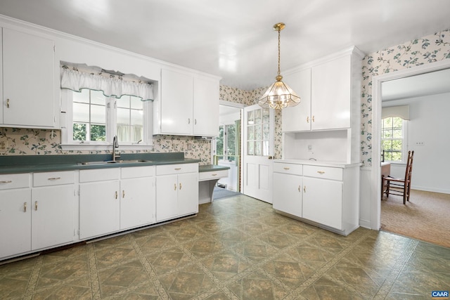 608 Davis Ave, Charlottesville, VA 22901 - kitchen featuring white cabinets, pendant lighting, dark countertops, and wallpapered walls
