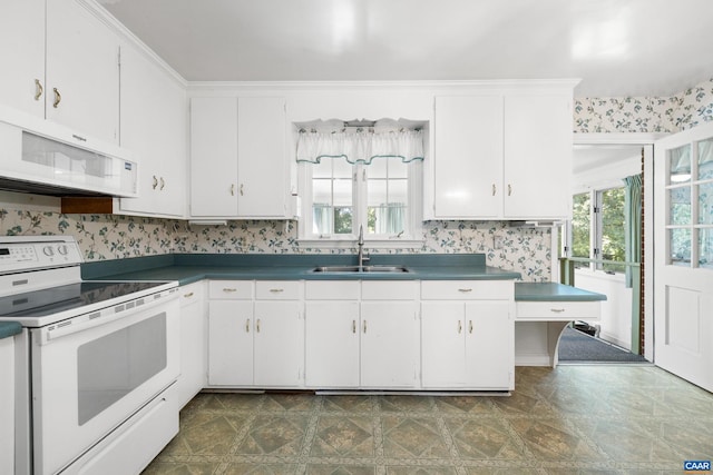 608 Davis Ave, Charlottesville, VA 22901 - kitchen featuring white appliances, plenty of natural light, white cabinetry, and dark countertops