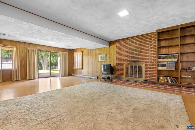 608 Davis Ave, Charlottesville, VA 22901 - unfurnished living room with baseboard heating, a brick fireplace, wood walls, and a textured ceiling