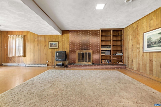 608 Davis Ave, Charlottesville, VA 22901 - living room with a baseboard radiator, wooden walls, a fireplace, built in shelves, and a textured ceiling