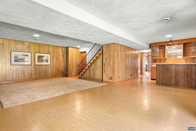 608 Davis Ave, Charlottesville, VA 22901 - finished below grade area with wooden walls, stairway, a textured ceiling, and bar