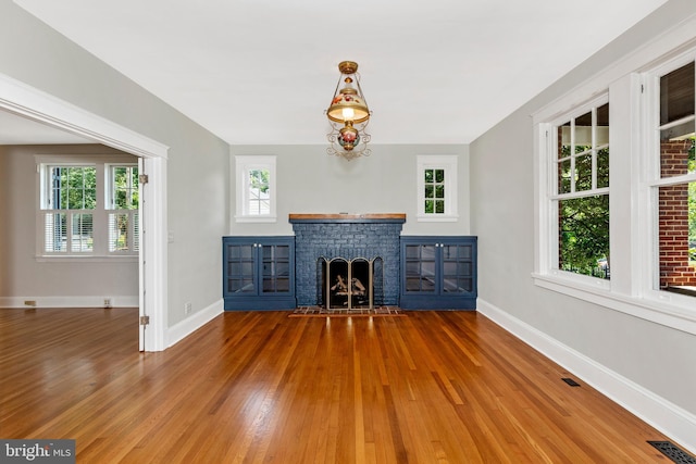 301 Fleming Ave, Frederick, MD 21701 - unfurnished living room with wood finished floors and a fireplace