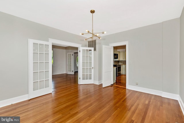 301 Fleming Ave, Frederick, MD 21701 - unfurnished dining area featuring french doors, light wood-style flooring, and a chandelier