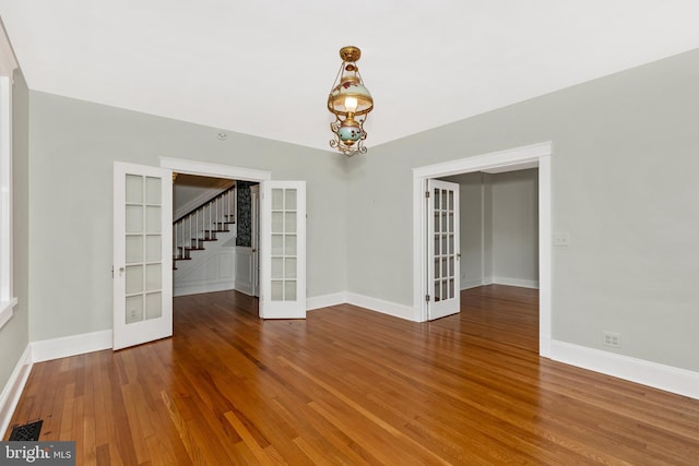 301 Fleming Ave, Frederick, MD 21701 - unfurnished room featuring french doors, stairs, and wood finished floors