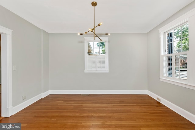 301 Fleming Ave, Frederick, MD 21701 - spare room with a chandelier, healthy amount of natural light, and wood finished floors