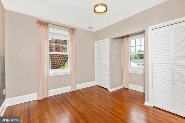 301 Fleming Ave, Frederick, MD 21701 - unfurnished bedroom featuring multiple closets and hardwood / wood-style floors