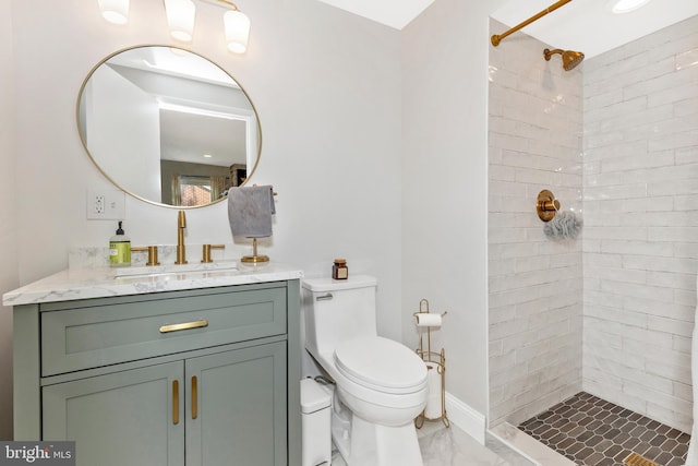 301 Fleming Ave, Frederick, MD 21701 - bathroom featuring marble look tiles, a tile shower, and vanity