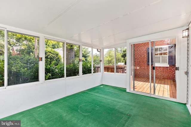 301 Fleming Ave, Frederick, MD 21701 - unfurnished sunroom with plenty of natural light, brick wall, and carpet floors