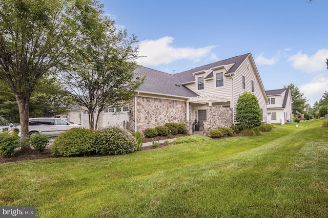 44357 Oakmont Manor Sq, Ashburn, VA 20147 - view of front of property with stone siding, a front lawn, and roof with shingles