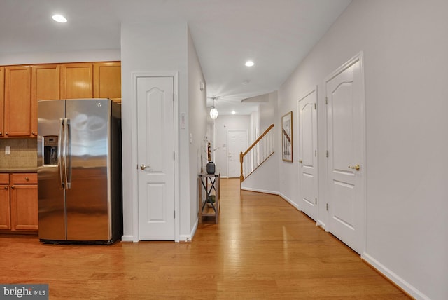 44357 Oakmont Manor Sq, Ashburn, VA 20147 - kitchen featuring stainless steel fridge, light wood-style flooring, brown cabinets, recessed lighting, and backsplash