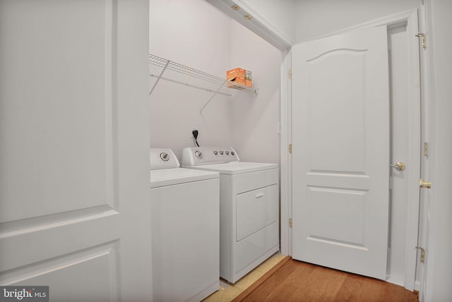 44357 Oakmont Manor Sq, Ashburn, VA 20147 - laundry area featuring washer and clothes dryer and light wood-style flooring