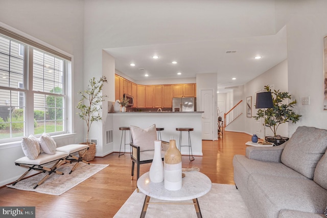 44357 Oakmont Manor Sq, Ashburn, VA 20147 - living room featuring light wood-style floors, stairway, and recessed lighting
