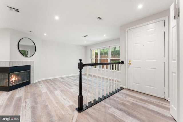 12560 Kempston Ln, Woodbridge, VA 22192 - entryway featuring wood finished floors, recessed lighting, and a tile fireplace