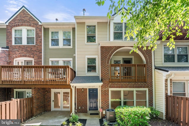12560 Kempston Ln, Woodbridge, VA 22192 - back of house featuring a balcony, french doors, and brick siding