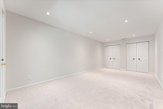 12560 Kempston Ln, Woodbridge, VA 22192 - unfurnished bedroom with multiple closets, recessed lighting, and light colored carpet