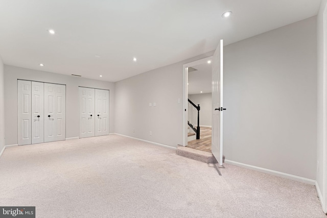 12560 Kempston Ln, Woodbridge, VA 22192 - basement featuring light colored carpet, stairs, and recessed lighting