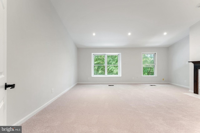 12560 Kempston Ln, Woodbridge, VA 22192 - unfurnished living room featuring a fireplace with flush hearth, light colored carpet, and recessed lighting