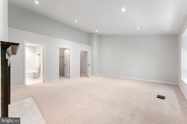 12560 Kempston Ln, Woodbridge, VA 22192 - unfurnished bedroom with a walk in closet, light colored carpet, recessed lighting, vaulted ceiling, and ensuite bathroom