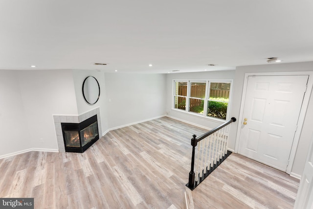 12560 Kempston Ln, Woodbridge, VA 22192 - unfurnished living room featuring a tiled fireplace, wood finished floors, and recessed lighting