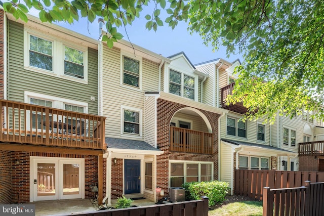 12560 Kempston Ln, Woodbridge, VA 22192 - rear view of property with a balcony and brick siding