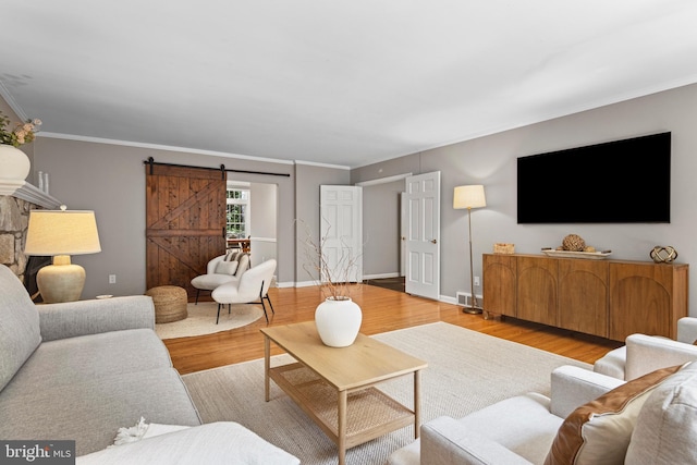13 Weirwood Rd, Wayne, PA 19087 - living area with a barn door, wood finished floors, and ornamental molding