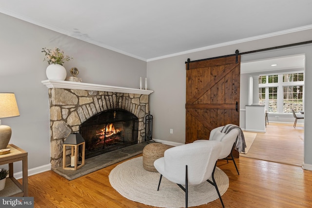 13 Weirwood Rd, Wayne, PA 19087 - living area featuring ornamental molding, wood finished floors, a stone fireplace, and a barn door