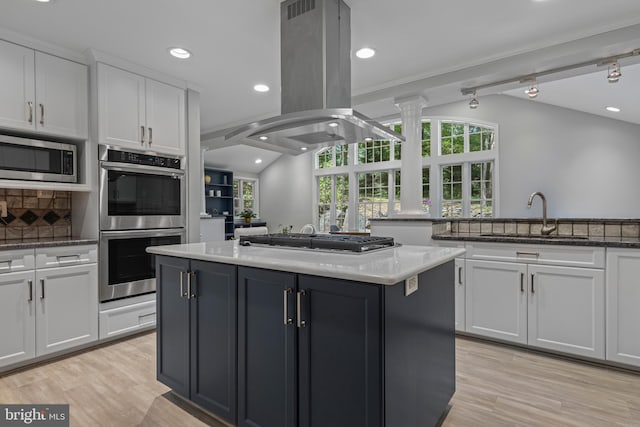 13 Weirwood Rd, Wayne, PA 19087 - kitchen with stainless steel appliances, island range hood, a center island, white cabinets, and recessed lighting