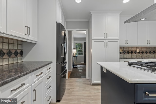 13 Weirwood Rd, Wayne, PA 19087 - kitchen with black fridge, wall chimney range hood, recessed lighting, dark stone countertops, and tasteful backsplash