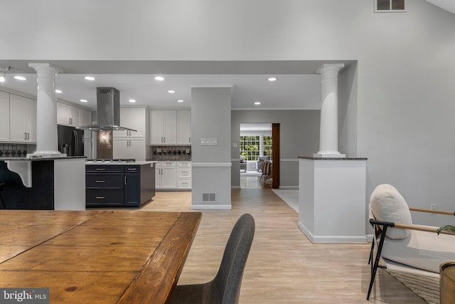 13 Weirwood Rd, Wayne, PA 19087 - dining area with decorative columns, light wood finished floors, and recessed lighting
