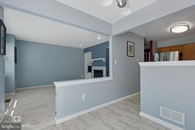 243 Prince William Way, Chalfont, PA 18914 - kitchen featuring freestanding refrigerator, brown cabinets, a fireplace, and open floor plan