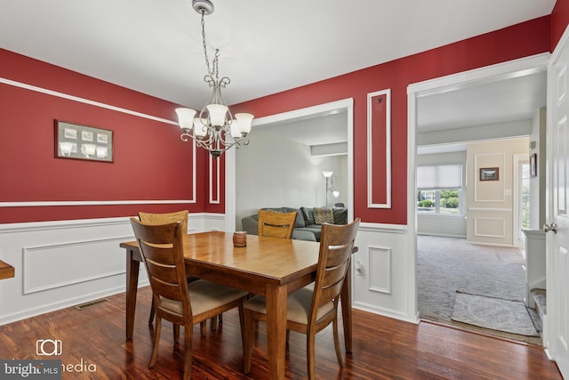243 Prince William Way, Chalfont, PA 18914 - dining space with a chandelier, a wainscoted wall, a decorative wall, and wood finished floors