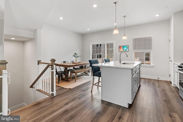 28 Boot Ln, Gilbertsville, PA 19525 - kitchen with dark wood finished floors, a kitchen island with sink, light countertops, pendant lighting, and a kitchen bar