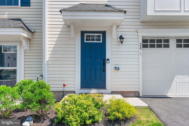 28 Boot Ln, Gilbertsville, PA 19525 - doorway to property featuring an attached garage and a shingled roof