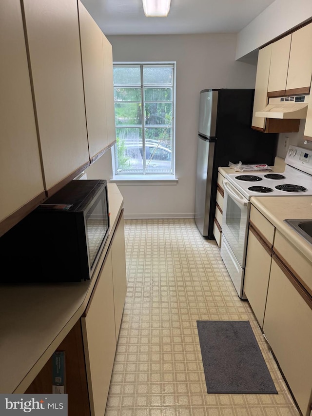 922 W Montgomery Ave Unit C-1, Ardmore, PA 19003 - kitchen featuring white electric stove, under cabinet range hood, light countertops, and light flooring