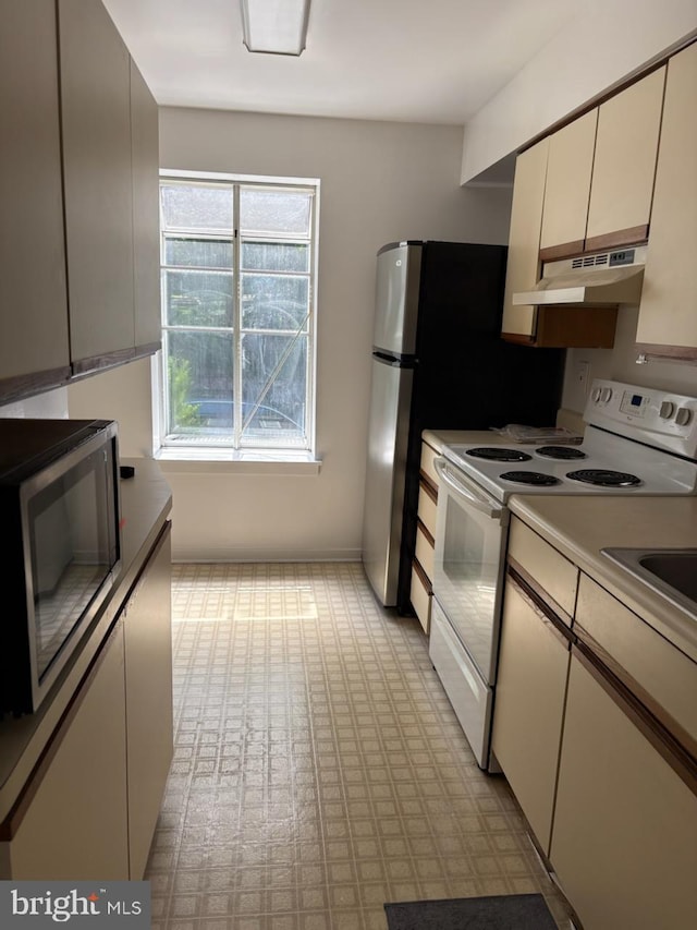 922 W Montgomery Ave Unit C-1, Ardmore, PA 19003 - kitchen with electric stove, stainless steel microwave, and under cabinet range hood