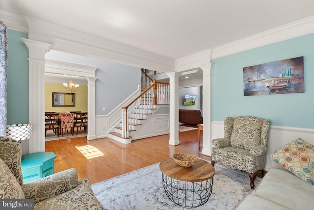 14512 Penderlea Ct, Gainesville, VA 20155 - living area featuring ornamental molding, decorative columns, wood finished floors, stairway, and a chandelier