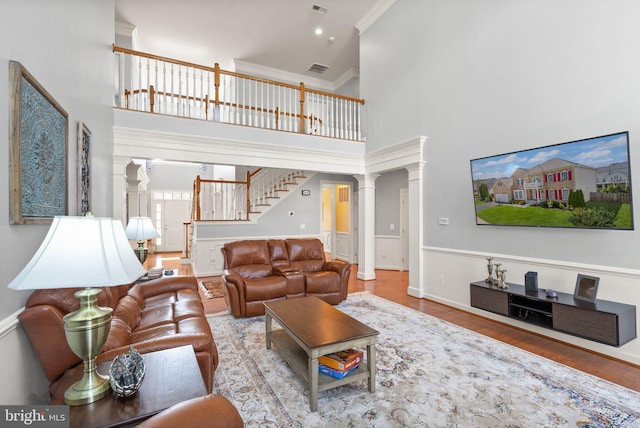 14512 Penderlea Ct, Gainesville, VA 20155 - living room with decorative columns, a towering ceiling, wood finished floors, ornamental molding, and stairway