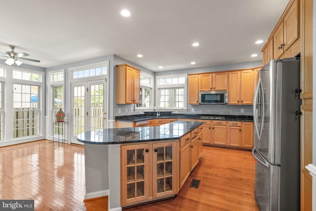 14512 Penderlea Ct, Gainesville, VA 20155 - kitchen with stainless steel appliances, light wood-style floors, plenty of natural light, a kitchen island, and recessed lighting