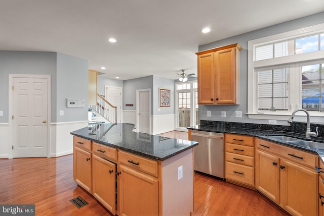 14512 Penderlea Ct, Gainesville, VA 20155 - kitchen featuring stainless steel dishwasher, light wood finished floors, a kitchen island, dark stone counters, and a ceiling fan