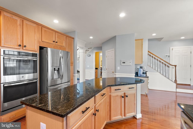 14512 Penderlea Ct, Gainesville, VA 20155 - kitchen with stainless steel appliances, wood finished floors, recessed lighting, a center island, and dark stone counters