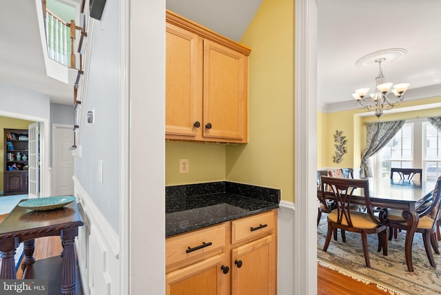 14512 Penderlea Ct, Gainesville, VA 20155 - kitchen featuring a chandelier, dark stone counters, light wood-type flooring, and ornamental molding