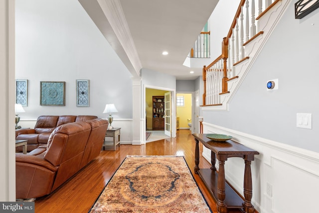 14512 Penderlea Ct, Gainesville, VA 20155 - living area featuring wood finished floors, stairs, crown molding, ornate columns, and recessed lighting