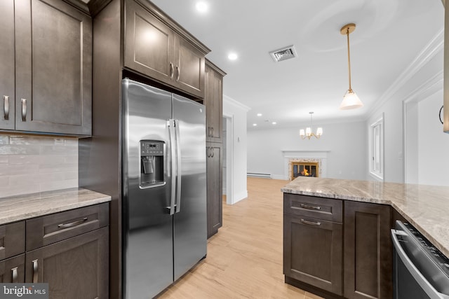 321 Persica Plz, Monroe Township, NJ 08831 - kitchen with appliances with stainless steel finishes, dark brown cabinetry, ornamental molding, backsplash, and light stone countertops