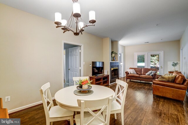 6532 Grange Ln Unit 103, Alexandria, VA 22315 - dining space featuring a chandelier, dark wood-type flooring, and a glass covered fireplace