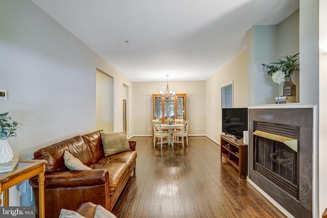 6532 Grange Ln Unit 103, Alexandria, VA 22315 - living room with a chandelier, dark wood-style flooring, and a fireplace