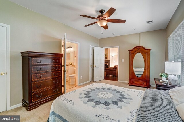 6532 Grange Ln Unit 103, Alexandria, VA 22315 - bedroom featuring light colored carpet, connected bathroom, and a ceiling fan