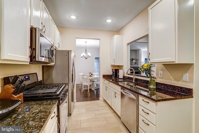 6532 Grange Ln Unit 103, Alexandria, VA 22315 - kitchen with appliances with stainless steel finishes, a chandelier, white cabinetry, dark stone counters, and recessed lighting