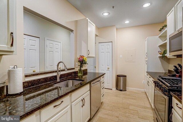 6532 Grange Ln Unit 103, Alexandria, VA 22315 - kitchen with appliances with stainless steel finishes, dark stone counters, white cabinets, open shelves, and recessed lighting