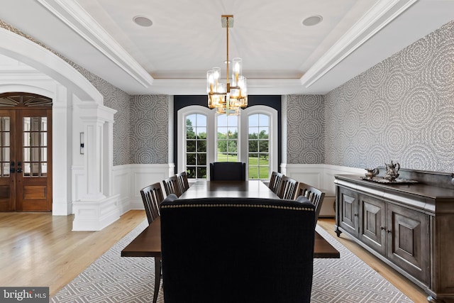 2740 Allen Glen Dr, Mechanicsburg, PA 17055 - dining area featuring light wood-style flooring, a tray ceiling, wallpapered walls, arched walkways, and a chandelier