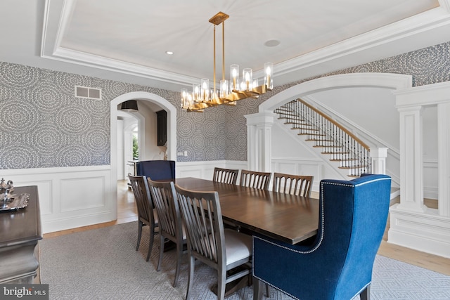 2740 Allen Glen Dr, Mechanicsburg, PA 17055 - dining room with arched walkways, wallpapered walls, wainscoting, a chandelier, and stairway